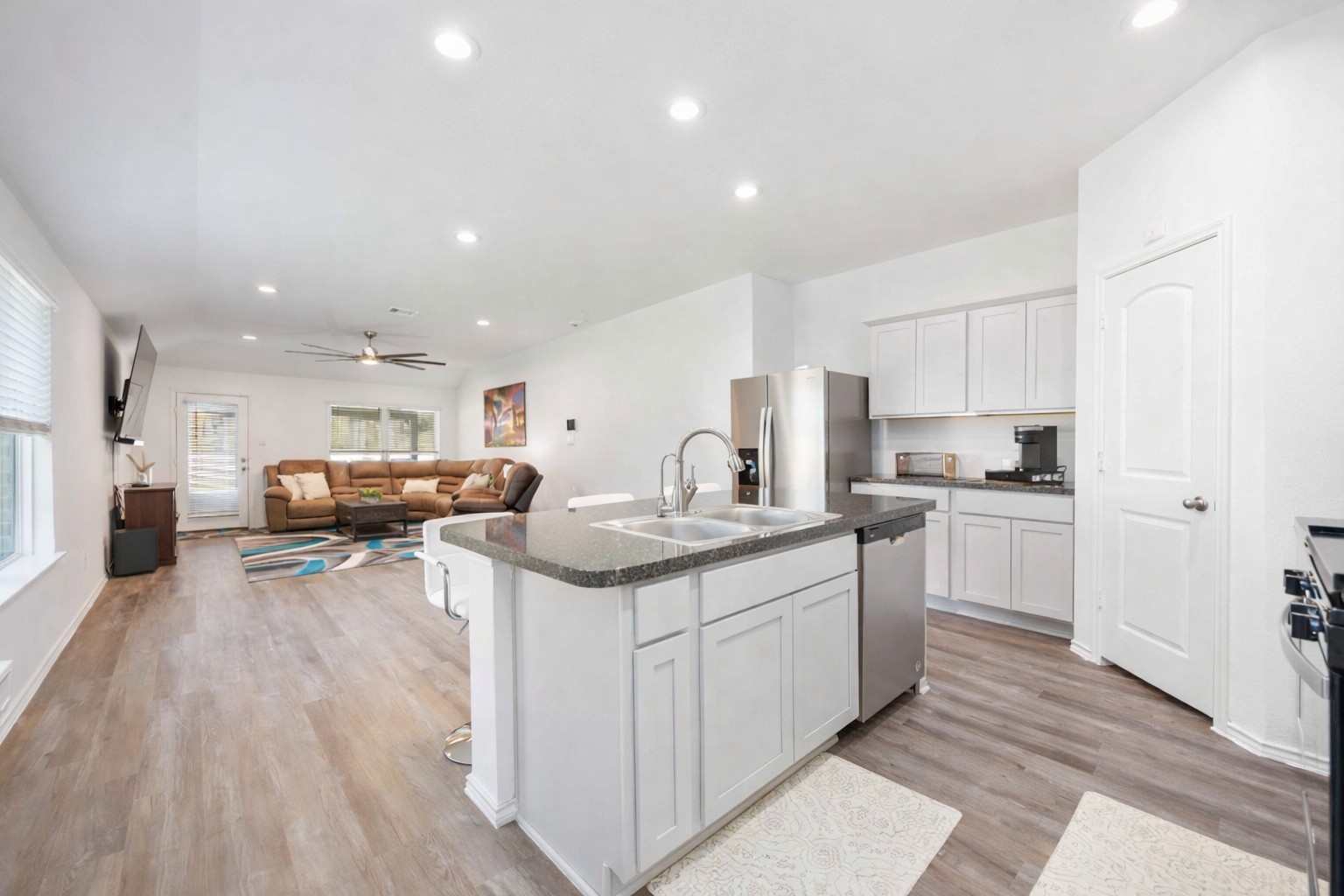 24034 Sunview Vly Drive Spring, TX 77373 - Photo 17 of 43 The open flow between living and kitchen spaces creates a welcoming atmosphere ideal for gathering, relaxing, or everyday routines, while the neutral palette allows the space to easily reflect your personal style.