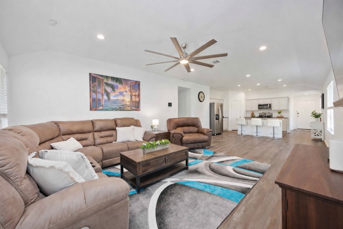 24034 Sunview Vly Drive Spring, TX 77373 - Photo 19 of 43 a living room with furniture kitchen view and a chandelier