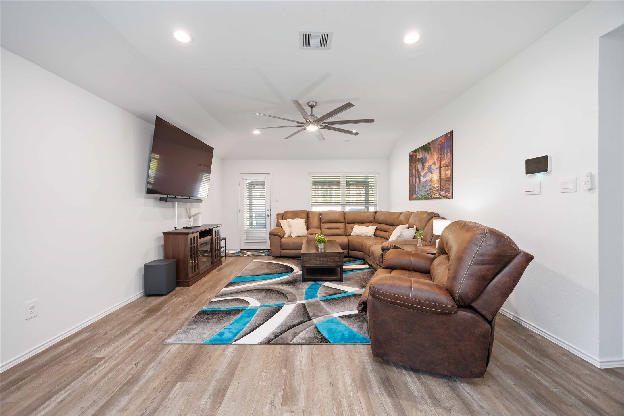 24034 Sunview Vly Drive Spring, TX 77373 - Photo 20 of 43 a living room with furniture a flat screen tv and a table