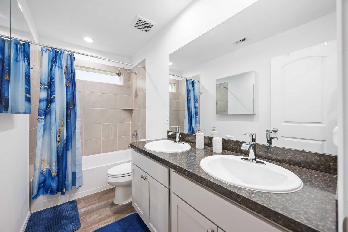 24034 Sunview Vly Drive Spring, TX 77373 - Photo 31 of 43 a bathroom with double vanity sinks a toilet a mirror and shower