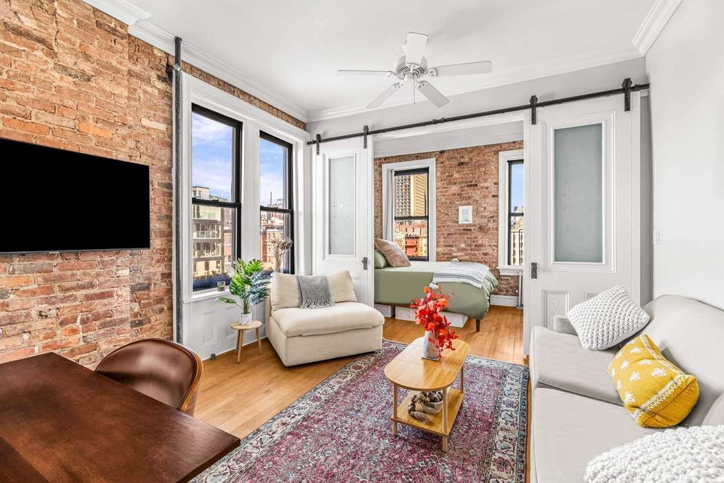64 MacDougal Street, Unit 22 Manhattan, NY 10012 - Photo 1 of 13 a living room with furniture fireplace and flat screen tv
