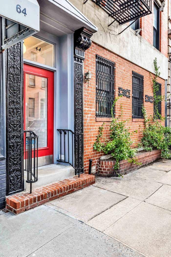 64 MacDougal Street, Unit 22 Manhattan, NY 10012 - Photo 11 of 13 a front view of a building with flower pots