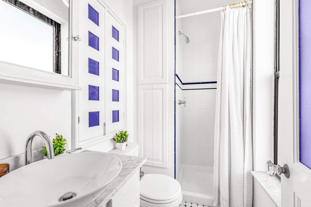 64 MacDougal Street, Unit 22 Manhattan, NY 10012 - Photo 5 of 13 a bathroom with a granite countertop sink toilet and shower