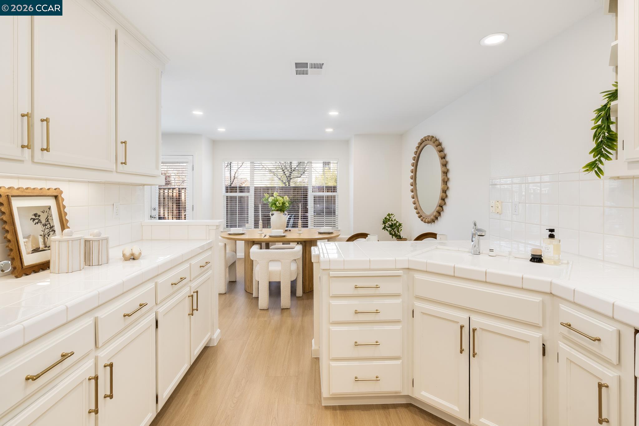 7110 Briza Loop San Ramon, CA 94582 - Photo 11 of 25 a kitchen with counter top space sink stove and cabinets