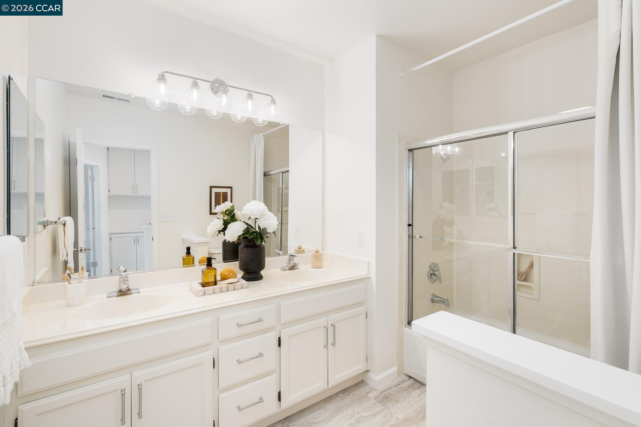 7110 Briza Loop San Ramon, CA 94582 - Photo 16 of 25 a bathroom with a double vanity sink mirror double and shower