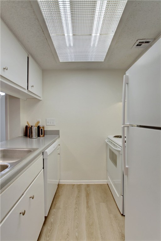 9079 Jollyville Road, Unit 303 Austin, TX 78759 - Photo 14 of 25 a kitchen with a sink and cabinets