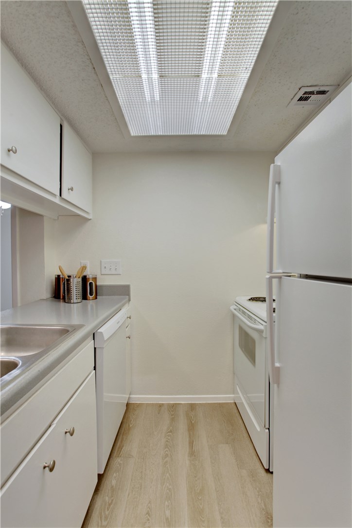 9079 Jollyville Road, Unit 303 Austin, TX 78759 - Photo 14 of 25 a kitchen with a sink and cabinets