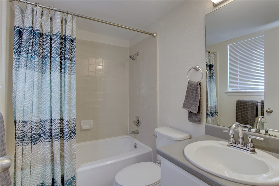 9079 Jollyville Road, Unit 303 Austin, TX 78759 - Photo 18 of 25 a bathroom with a sink toilet and shower