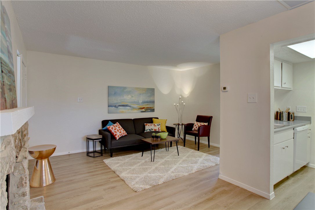 9079 Jollyville Road, Unit 303 Austin, TX 78759 - Photo 4 of 25 a living room with furniture and a wooden floor
