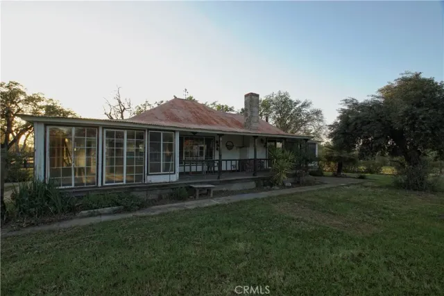 a view of a house with a yard and sitting area