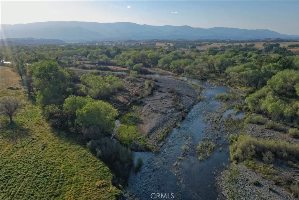 15385 Weston Road Corning, CA 96029 - Photo 8 of 75 an aerial view of green landscape with trees houses and mountain view