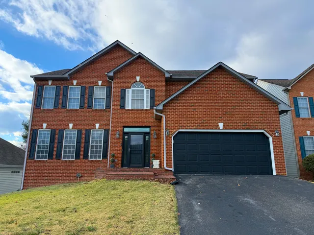 a front view of a house with yard and garage