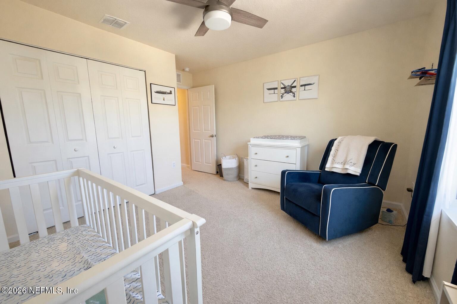 597 Coastline Way Street St. Augustine, FL 32092 - Photo 21 of 21 a living room with furniture and a baby crib