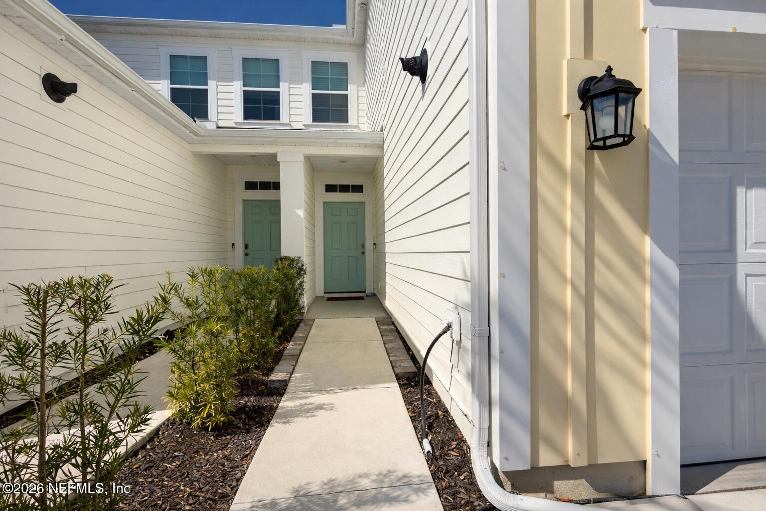 597 Coastline Way Street St. Augustine, FL 32092 - Photo 3 of 21 a view of a pathway of a house with potted plants