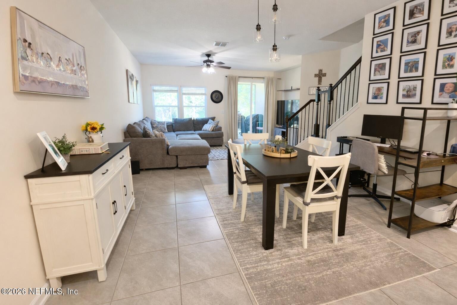 597 Coastline Way Street St. Augustine, FL 32092 - Photo 8 of 21 a living room with furniture a chandelier and a dining table