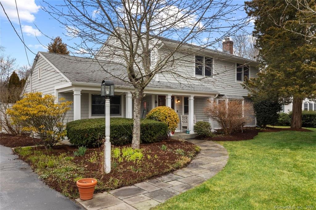 a front view of a house with a garden and porch