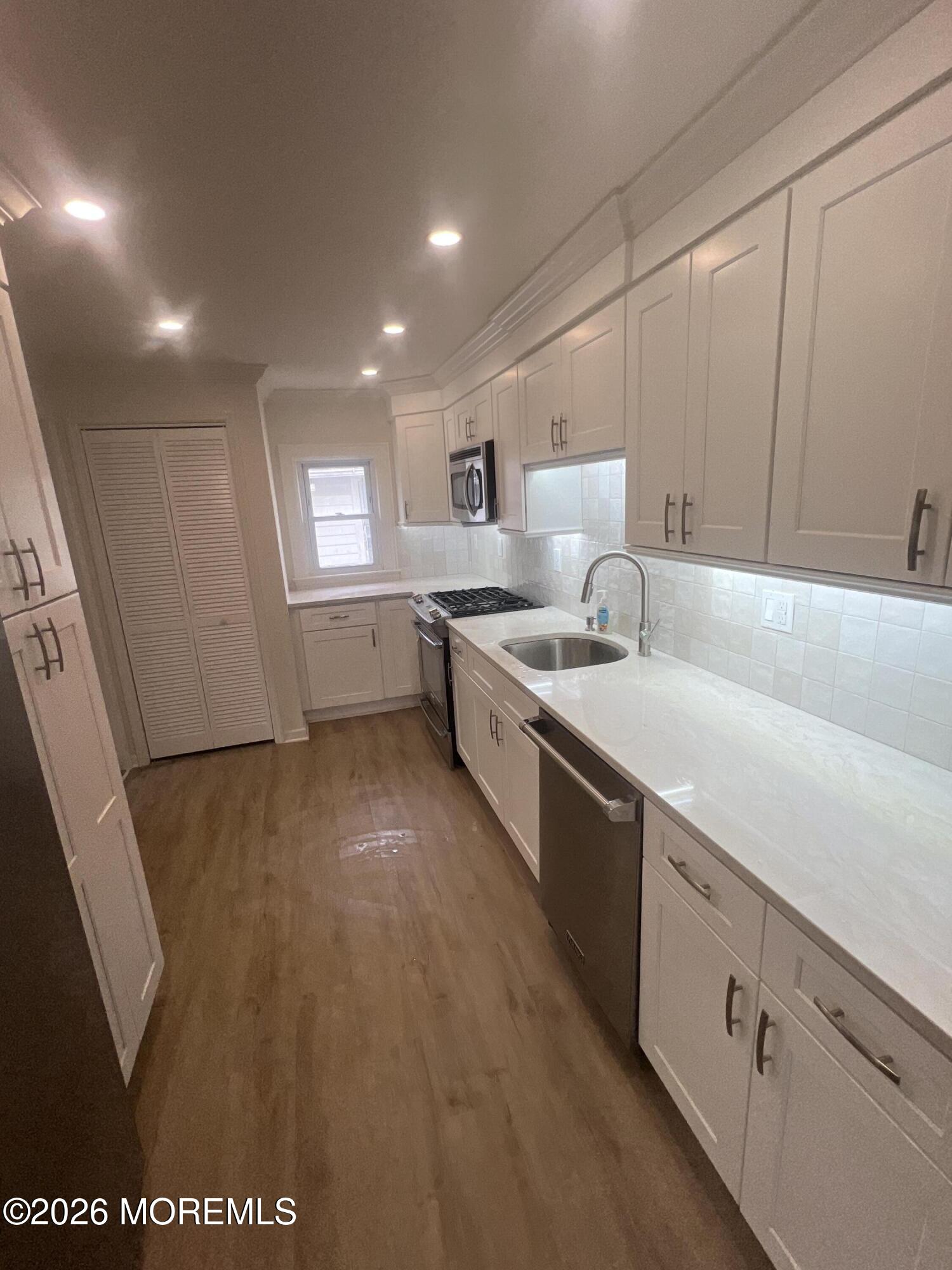 33 Weaverville Road Freehold, NJ 07728 - Photo 2 of 12 a large white kitchen with sink and washing machine