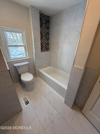 a bath room with a toilet and a shower
