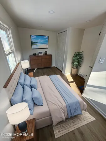 a bedroom with furniture and a potted plant