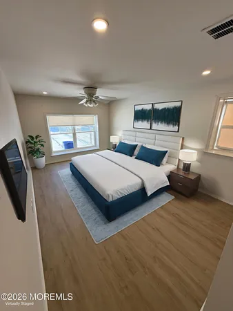a bedroom with double bed and a large window