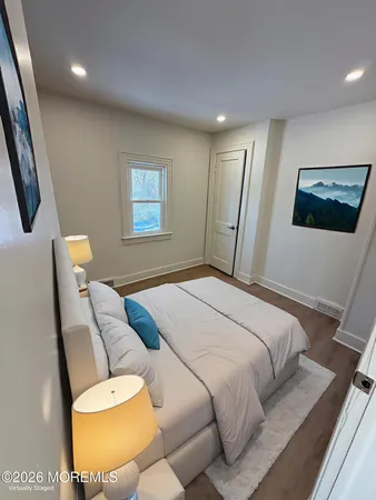 a bedroom with a bed and a painting on the wall
