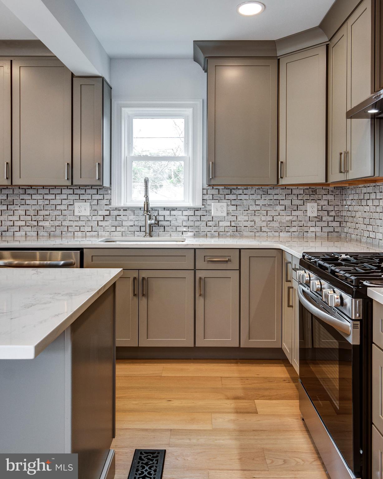 13 Wilkins Avenue Haddonfield, NJ 08033 - Photo 12 of 49 a kitchen with stainless steel appliances granite countertop a sink stove and cabinets