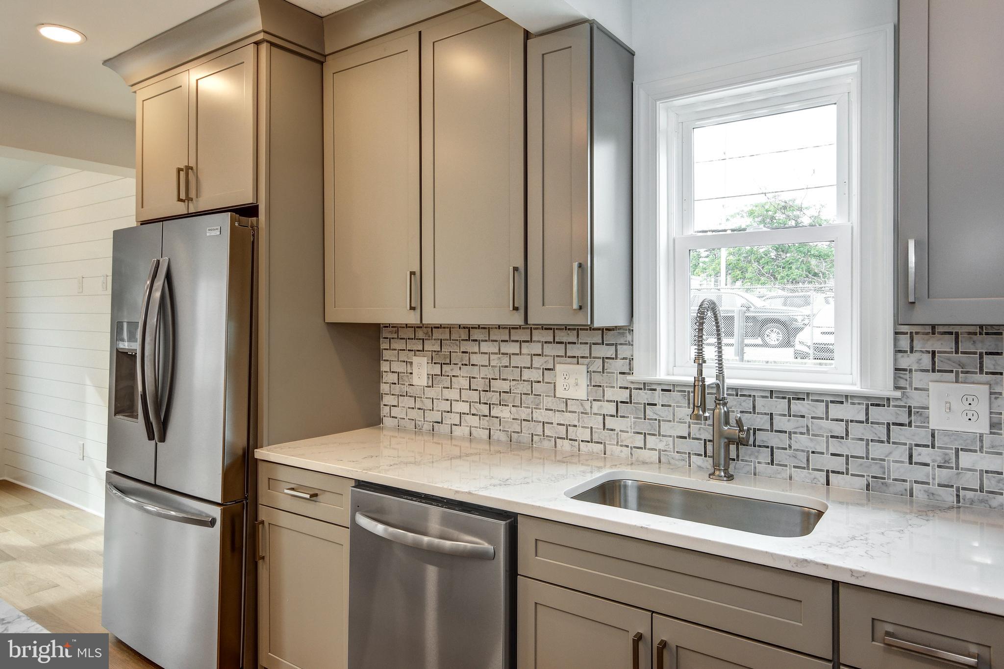 13 Wilkins Avenue Haddonfield, NJ 08033 - Photo 14 of 49 a view of a kitchen with a refrigerator and sink