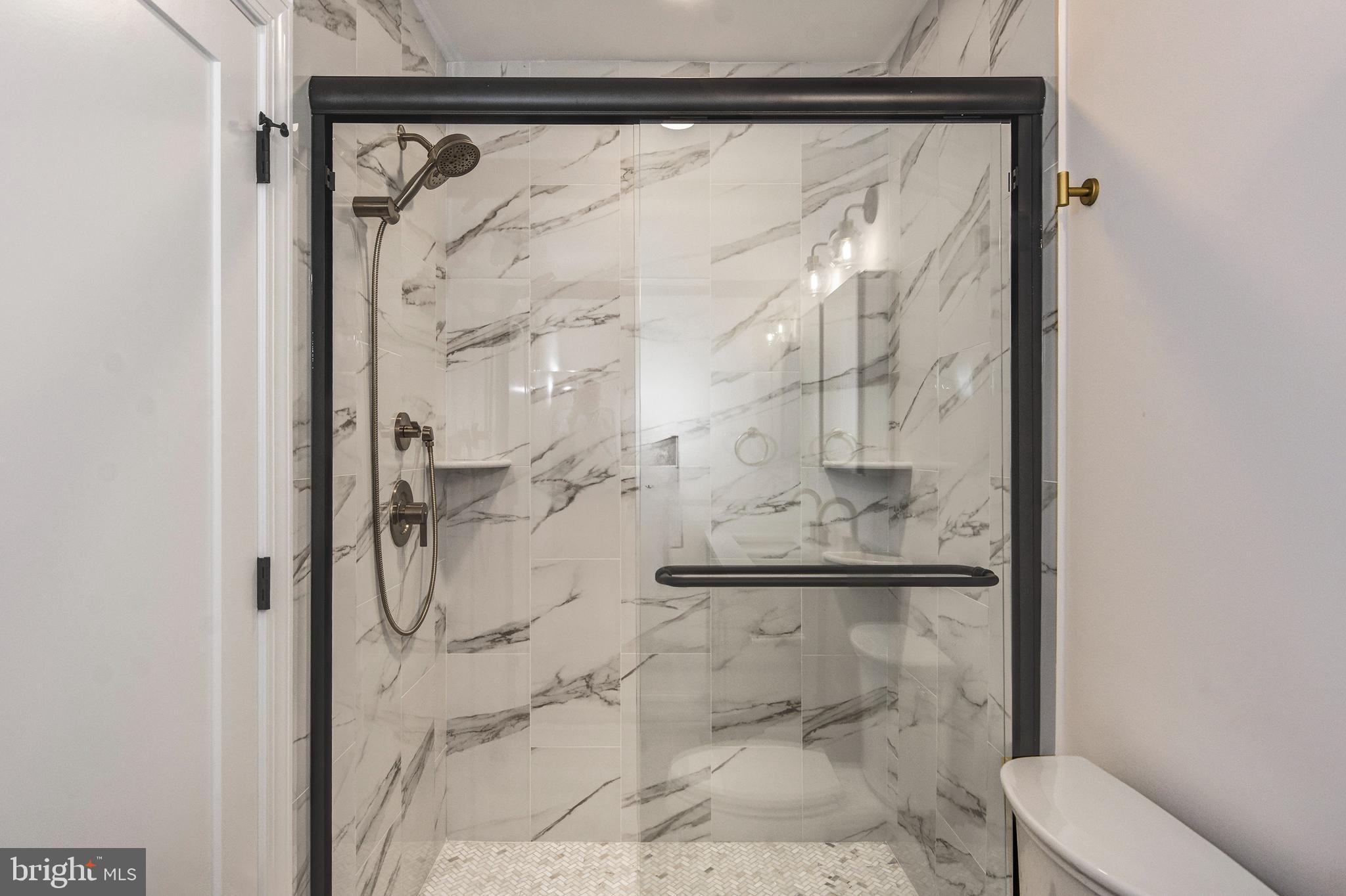 13 Wilkins Avenue Haddonfield, NJ 08033 - Photo 23 of 49 a bathroom with a glass shower door
