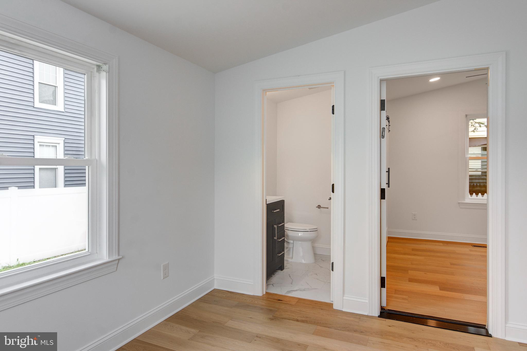 13 Wilkins Avenue Haddonfield, NJ 08033 - Photo 29 of 49 a view of an empty room with wooden floor and a bathroom