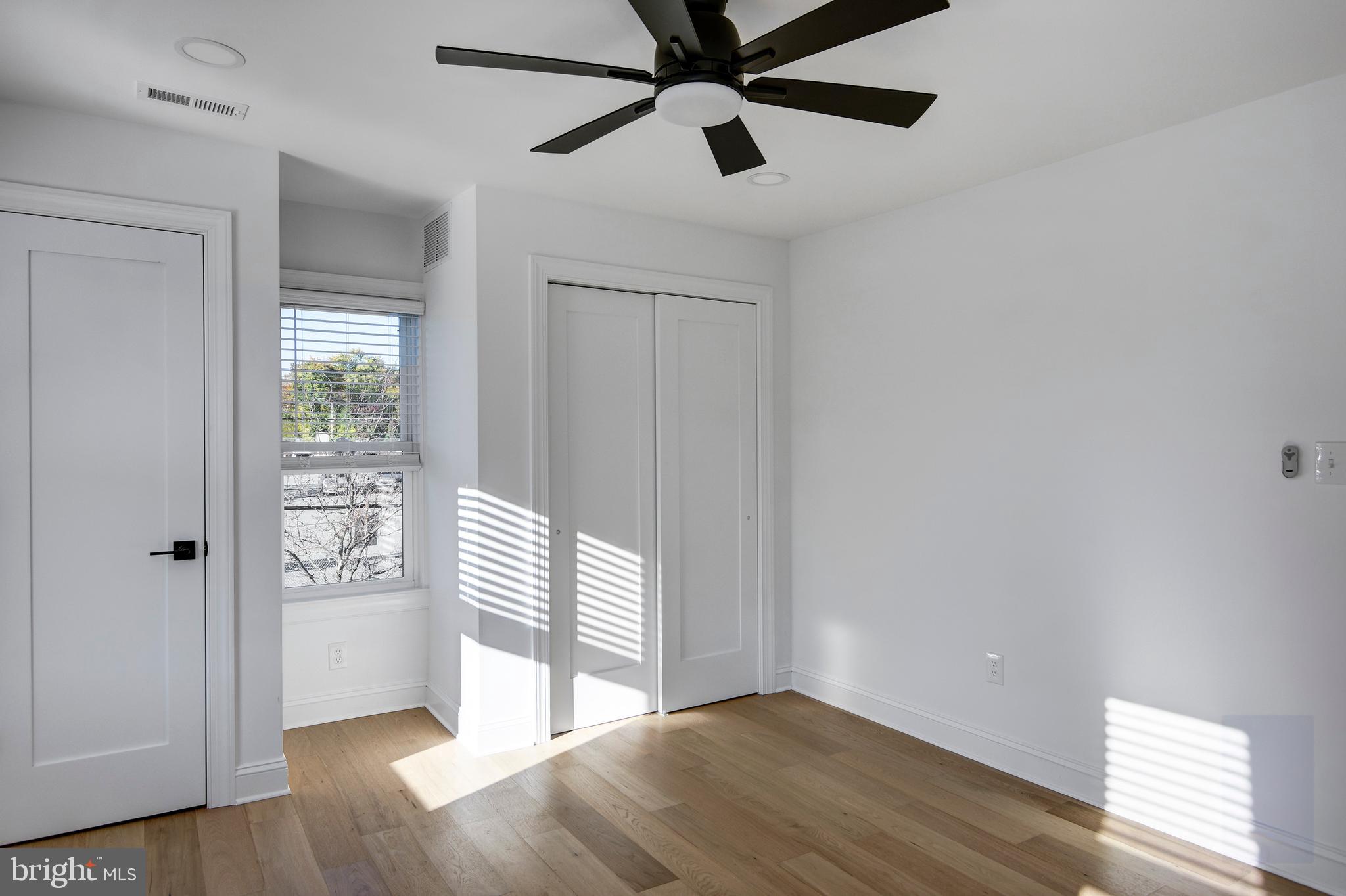 13 Wilkins Avenue Haddonfield, NJ 08033 - Photo 43 of 49 a view of an empty room with wooden floor and a window