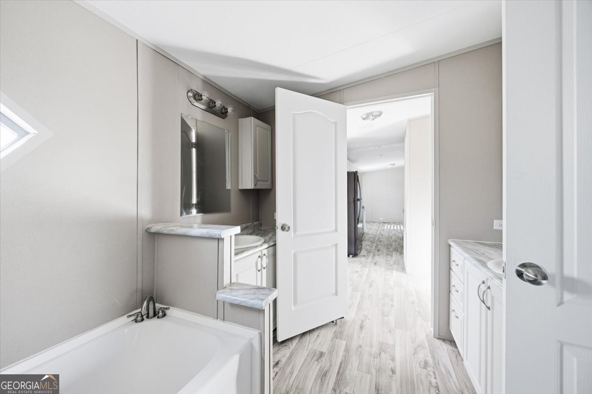 583 Greene Settlement Road Gray, GA 31032 - Photo 12 of 25 a bathroom with a sink and mirror