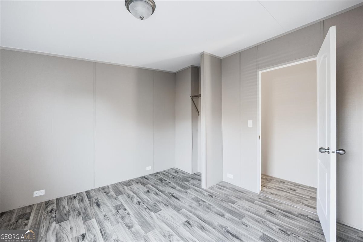 583 Greene Settlement Road Gray, GA 31032 - Photo 14 of 25 a view of empty room with wooden floor