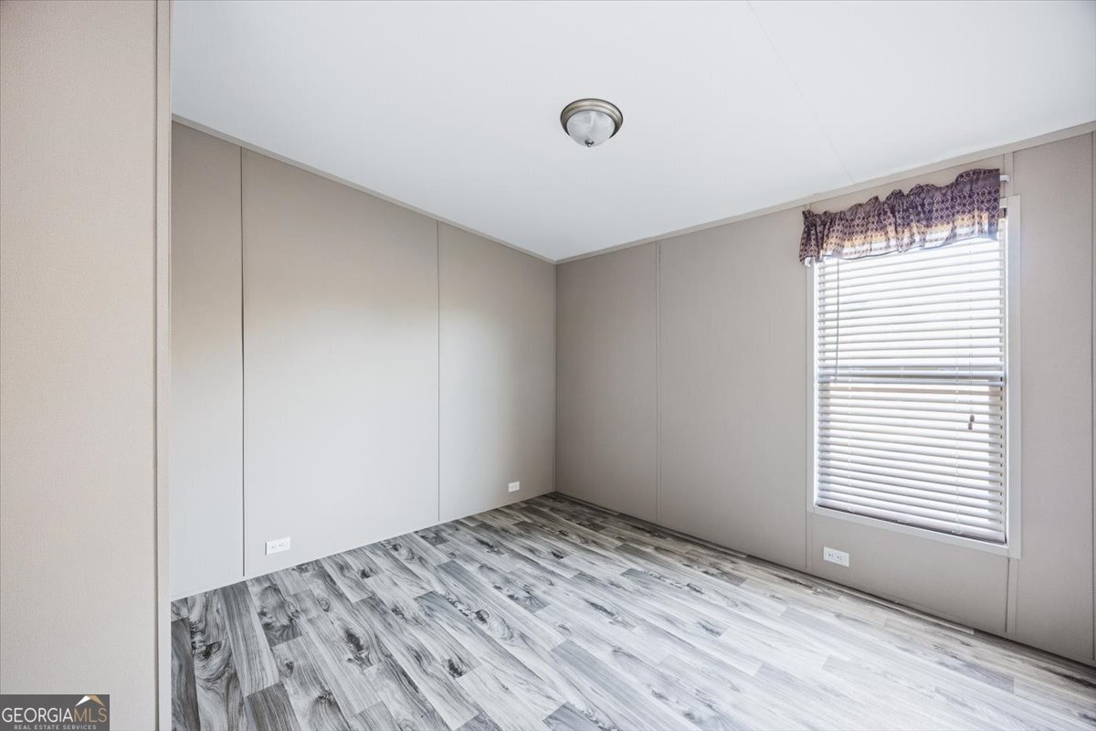 583 Greene Settlement Road Gray, GA 31032 - Photo 15 of 25 a view of empty room with wooden floor and fan