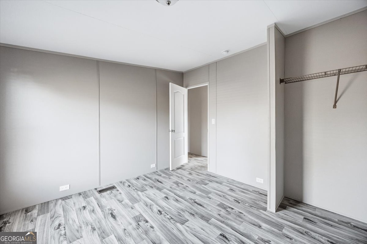 583 Greene Settlement Road Gray, GA 31032 - Photo 16 of 25 a view of a room with wooden floor