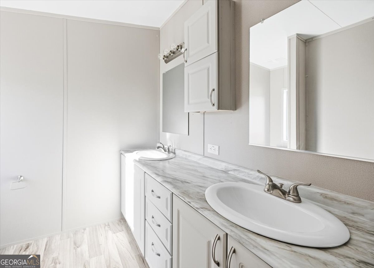 583 Greene Settlement Road Gray, GA 31032 - Photo 17 of 25 a bathroom with a double vanity sink and a mirror