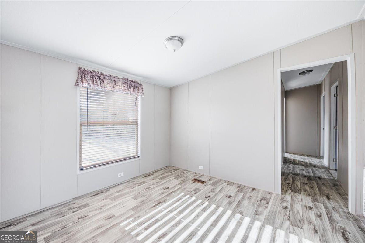 583 Greene Settlement Road Gray, GA 31032 - Photo 6 of 25 a view of empty room with wooden floor and fan