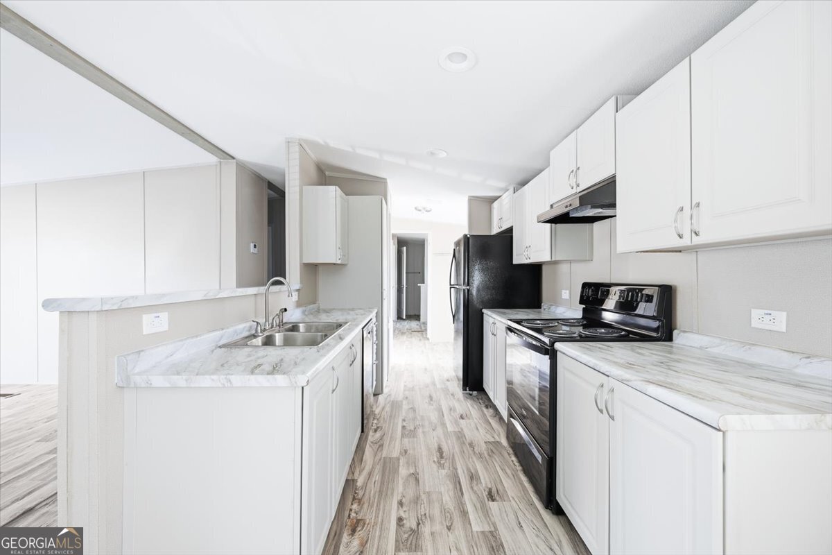 583 Greene Settlement Road Gray, GA 31032 - Photo 7 of 25 a kitchen with stainless steel appliances granite countertop a sink stove refrigerator and cabinets
