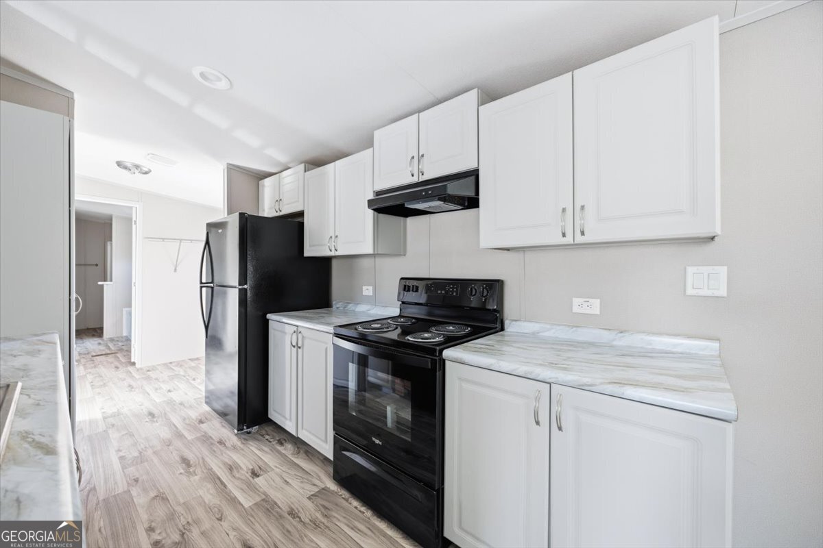 583 Greene Settlement Road Gray, GA 31032 - Photo 8 of 25 a kitchen with stainless steel appliances granite countertop a stove a refrigerator and a white cabinets