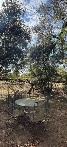 a backyard of a house with table and chairs