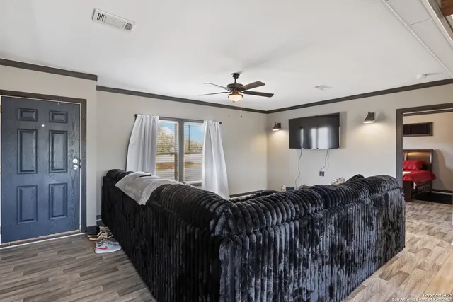 a living room with a bed furniture and a large window