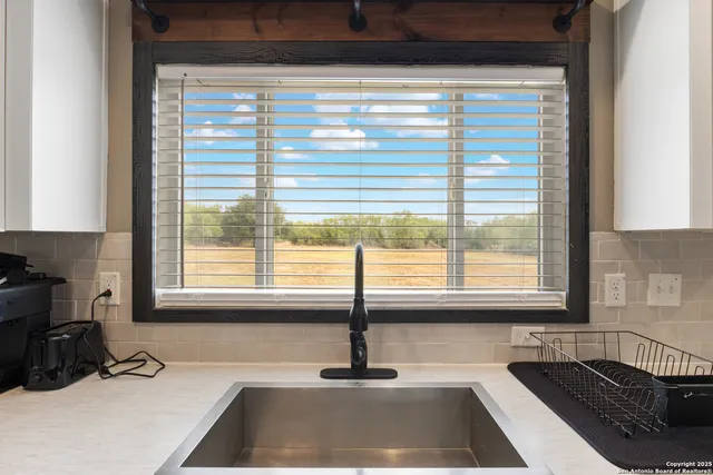 a kitchen with a window a sink and a counter top