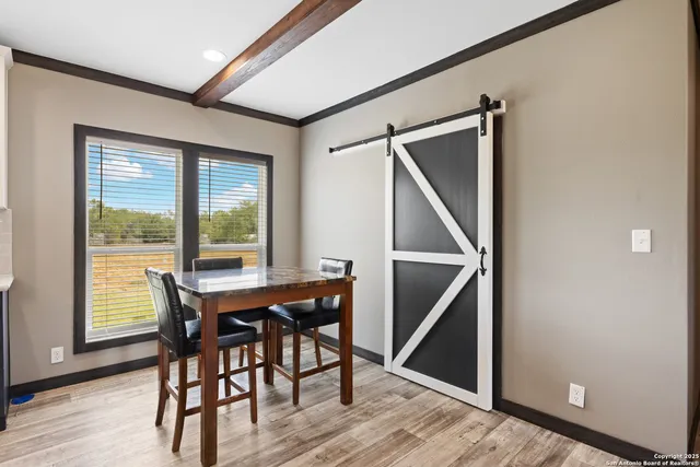 a view of a dining room with furniture and wooden floor