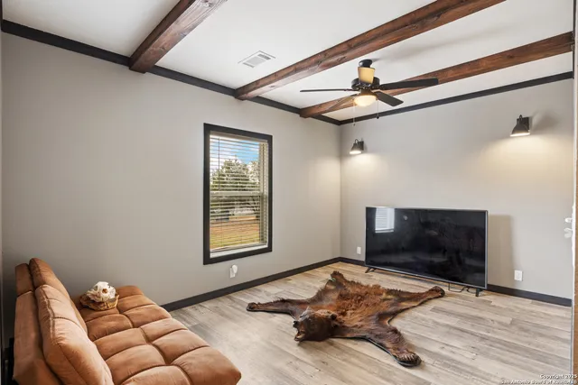 a bedroom with furniture or bed and a flat screen tv