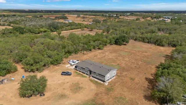 an aerial view of a house with a yard