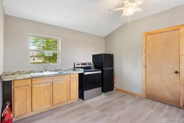 a kitchen with a stove a sink and a refrigerator