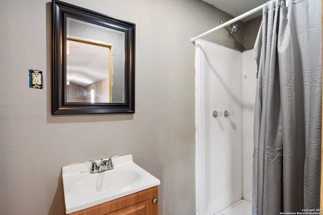a bathroom with a sink and mirror