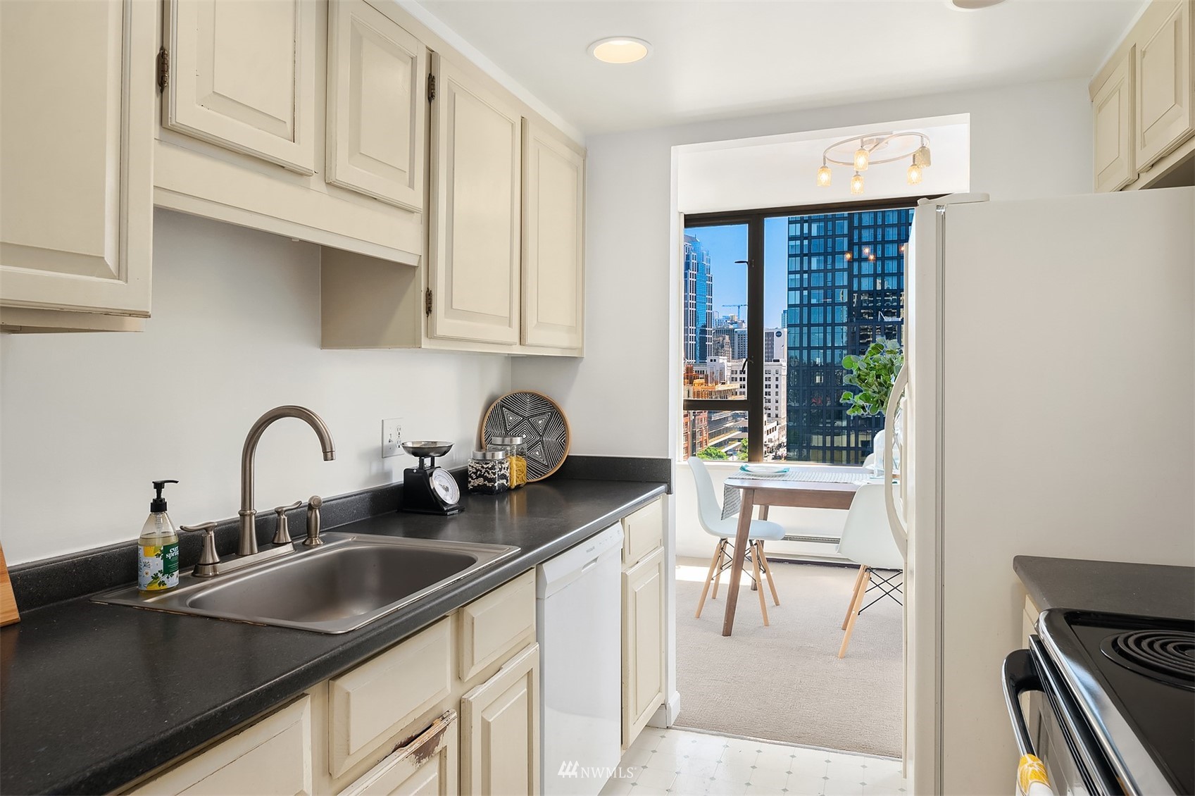 2201 3rd Avenue, Unit 1501 Seattle, WA 98121 - Photo 14 of 34 a kitchen with a sink cabinets and appliances