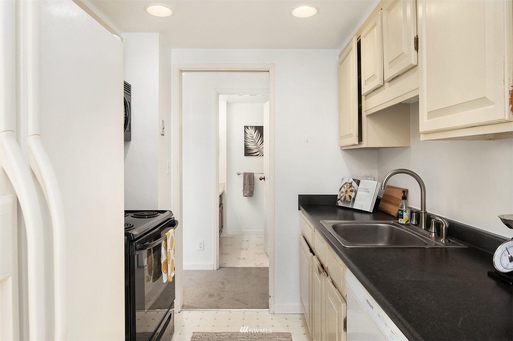 2201 3rd Avenue, Unit 1501 Seattle, WA 98121 - Photo 15 of 34 a kitchen with stainless steel appliances granite countertop a sink stove and refrigerator