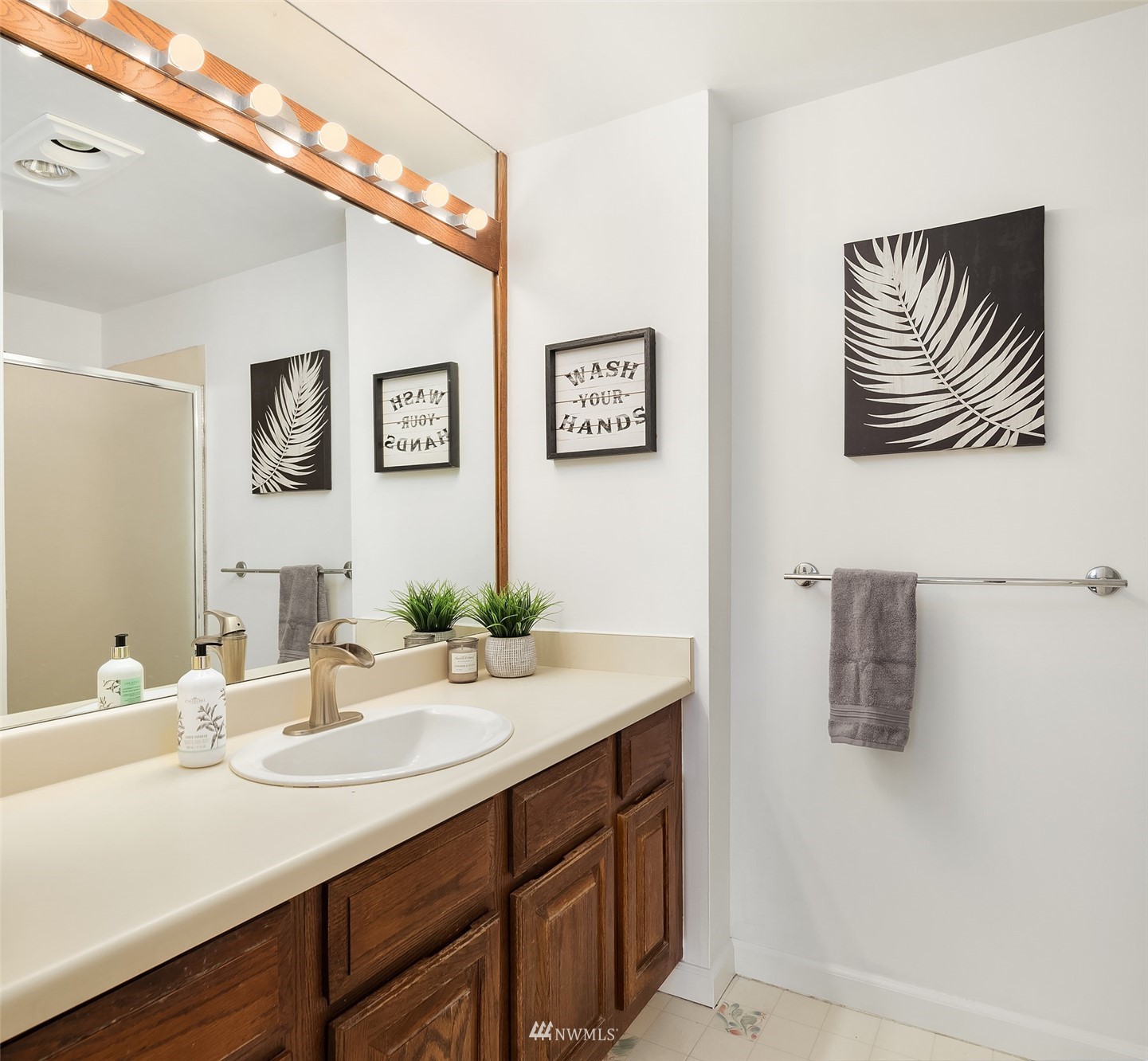 2201 3rd Avenue, Unit 1501 Seattle, WA 98121 - Photo 22 of 34 a bathroom with a sink a mirror and painting on the wall