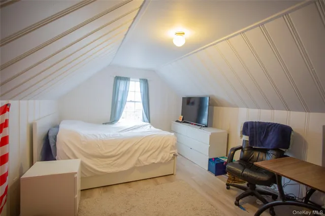 a bedroom with a bed chair and a desk